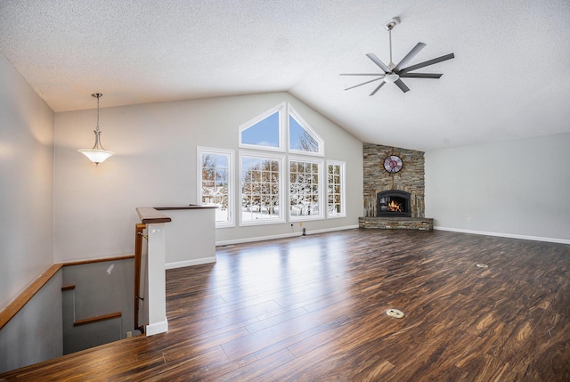 unfurnished living room featuring a fireplace, ceiling fan, dark hardwood / wood-style flooring, and a textured ceiling