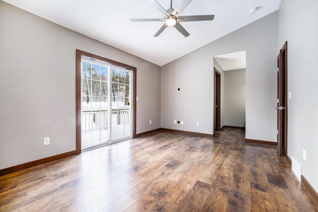 unfurnished room with a textured ceiling, ceiling fan, dark hardwood / wood-style flooring, and lofted ceiling