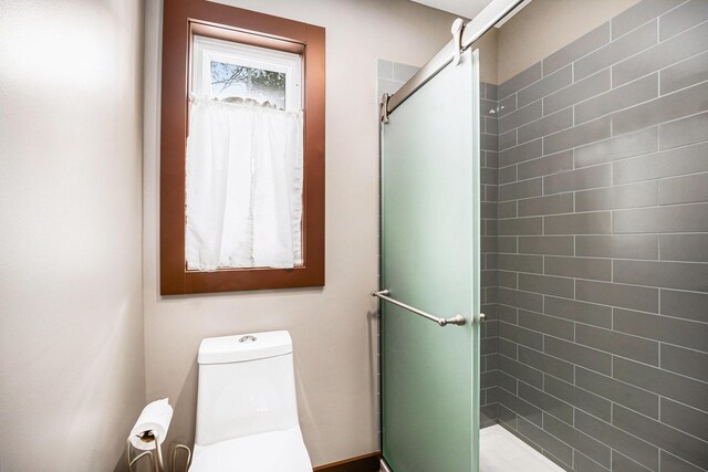 bathroom with toilet and an enclosed shower