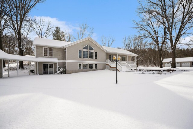 view of snow covered rear of property