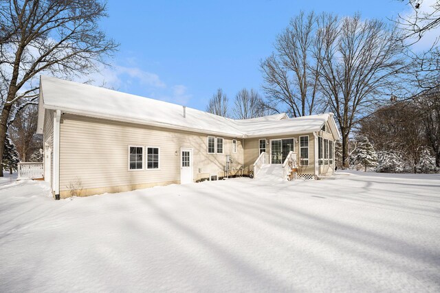 view of snow covered back of property