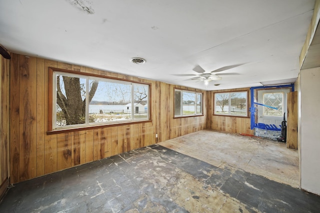 interior space featuring ceiling fan and a healthy amount of sunlight