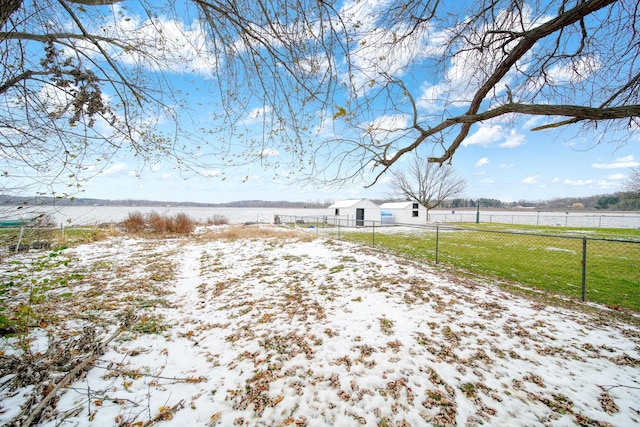 yard layered in snow featuring a rural view