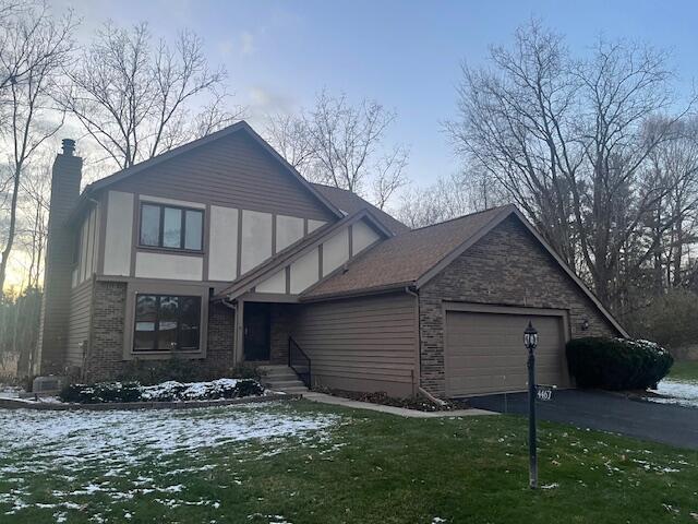 4467 Copperhill Dr, Okemos, MI 48864 - tudor house featuring a garage and a lawn