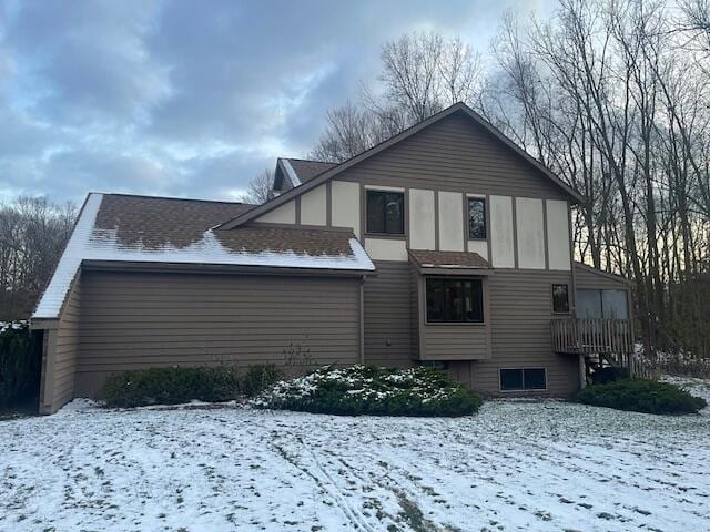 view of snow covered rear of property