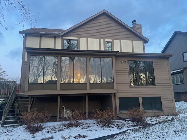 view of snow covered back of property