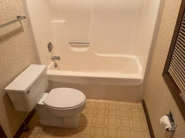 bathroom with toilet and tub / shower combination