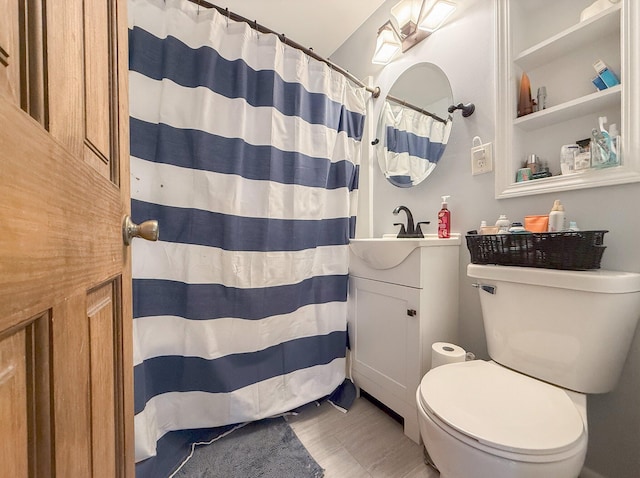 bathroom featuring a shower with shower curtain, vanity, and toilet