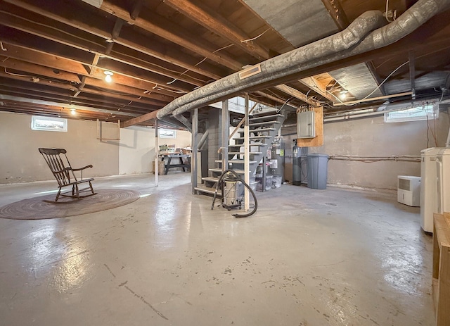 basement with electric panel and washer / clothes dryer