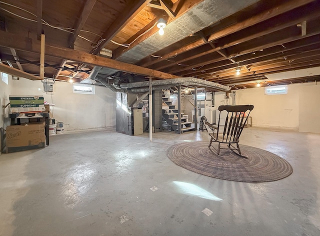 basement featuring washer / dryer, heating unit, and a healthy amount of sunlight