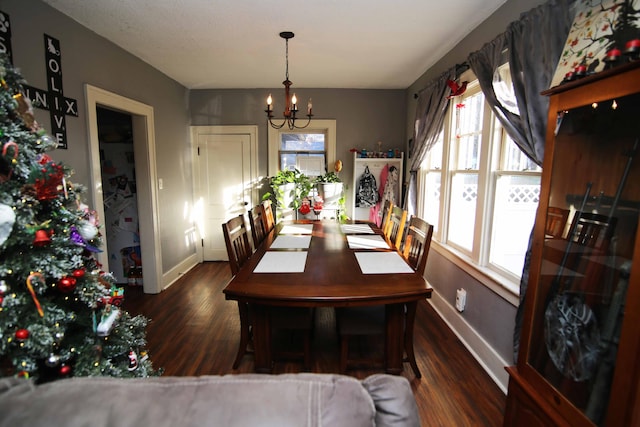 dining room featuring dark hardwood / wood-style floors and a chandelier