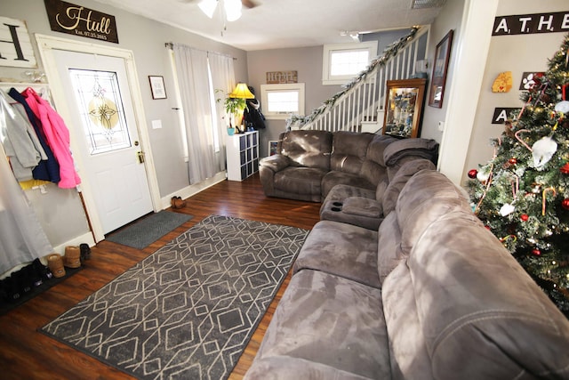 living room featuring ceiling fan and dark hardwood / wood-style floors