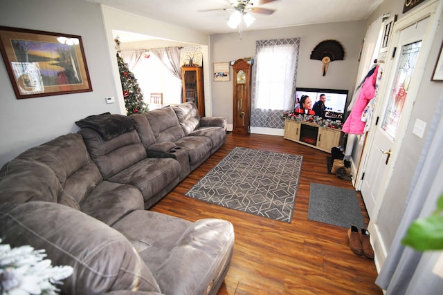 living room featuring dark hardwood / wood-style flooring and ceiling fan