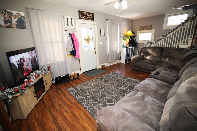 living room featuring dark hardwood / wood-style flooring and ceiling fan