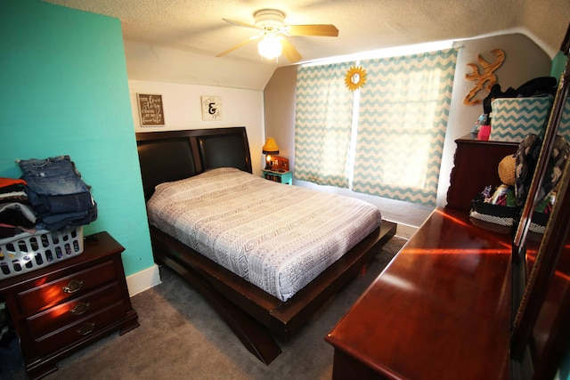 carpeted bedroom with ceiling fan, lofted ceiling, and a textured ceiling