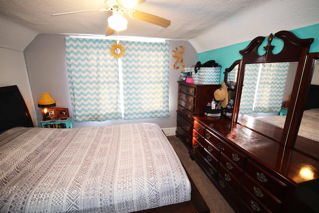 bedroom with a textured ceiling, ceiling fan, carpet flooring, and lofted ceiling