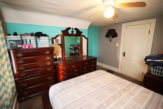 bedroom with ceiling fan and a textured ceiling