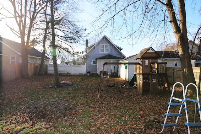 rear view of property featuring a playground