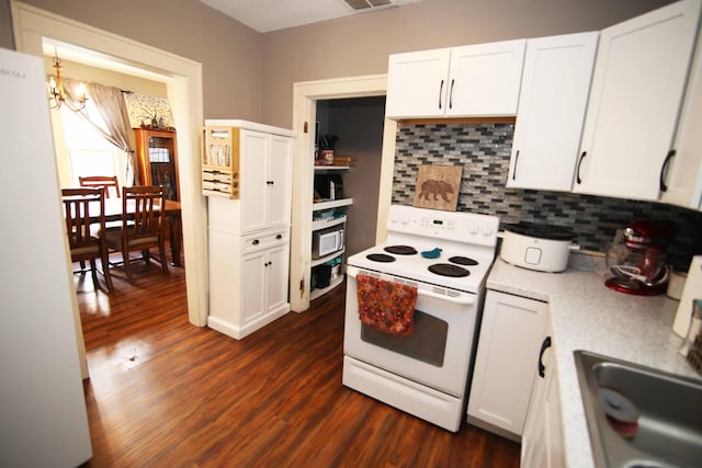 kitchen featuring white cabinets, white appliances, and dark wood-type flooring