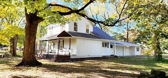 farmhouse-style home with covered porch and a garage