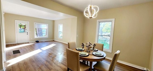 dining space featuring plenty of natural light and dark hardwood / wood-style floors