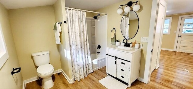 full bathroom with shower / tub combo, vanity, hardwood / wood-style flooring, and toilet