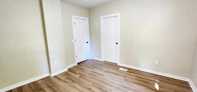 unfurnished bedroom with light wood-type flooring