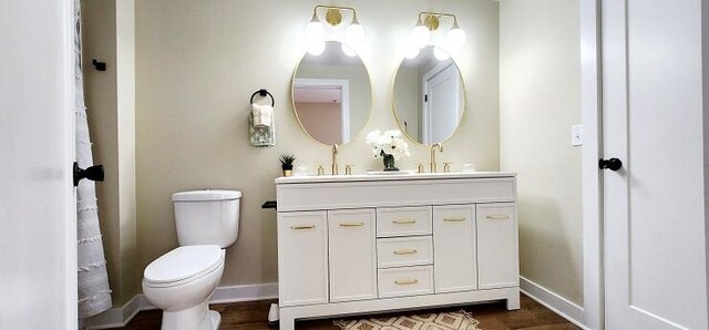 bathroom featuring hardwood / wood-style floors, vanity, and toilet