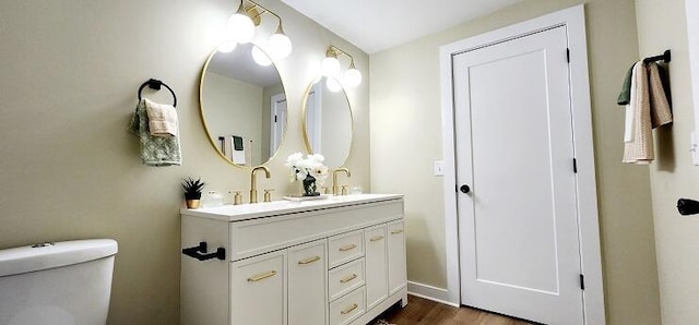 bathroom featuring hardwood / wood-style floors, vanity, and toilet