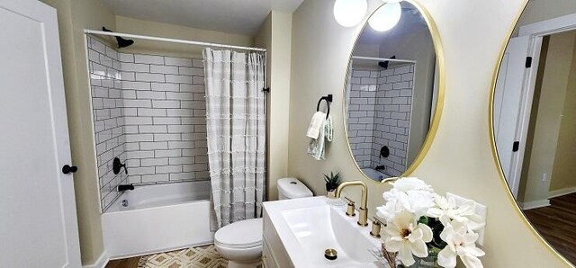 full bathroom with shower / tub combo, hardwood / wood-style flooring, toilet, and sink