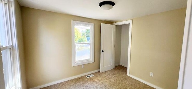 unfurnished bedroom featuring light colored carpet