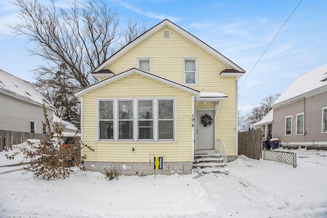 view of snow covered back of property