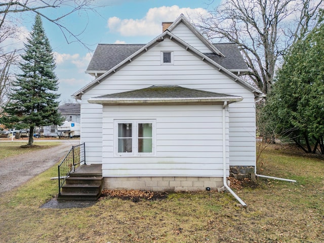 view of property exterior with a yard