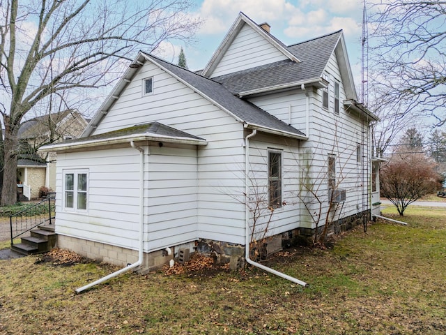 view of side of home with a lawn