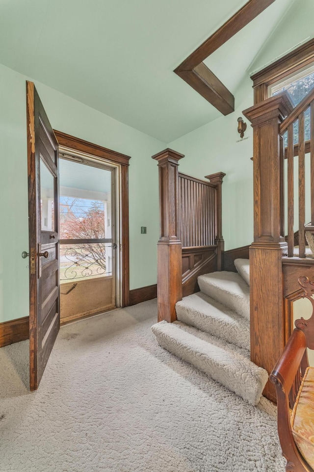 staircase with carpet flooring and vaulted ceiling