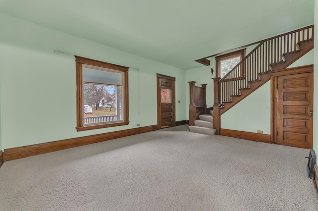 unfurnished living room with a healthy amount of sunlight and carpet floors