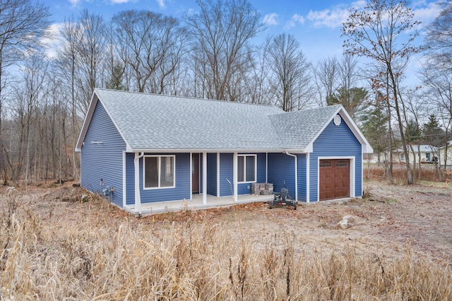 ranch-style house with a porch and a garage