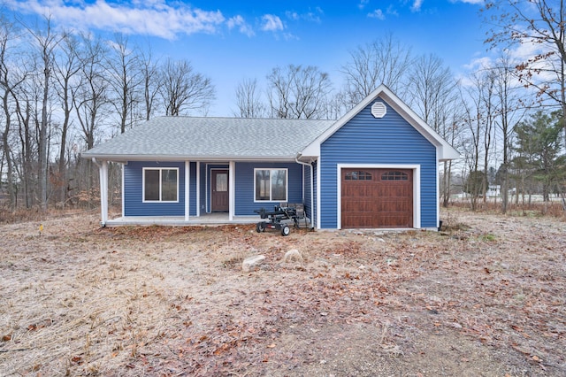 single story home with a porch and a garage