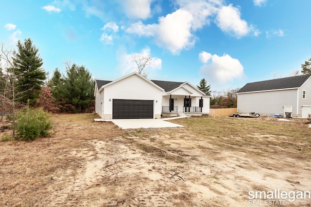 view of front of property with a porch and a garage