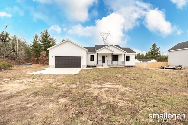 modern farmhouse style home with a front yard, a porch, and a garage