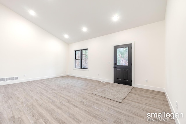 entrance foyer with light hardwood / wood-style flooring and lofted ceiling