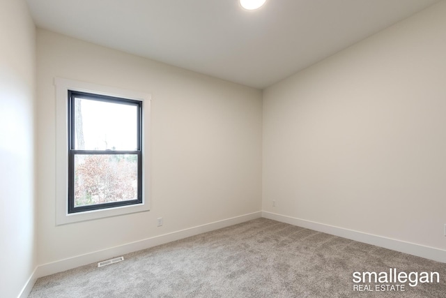 empty room with light colored carpet