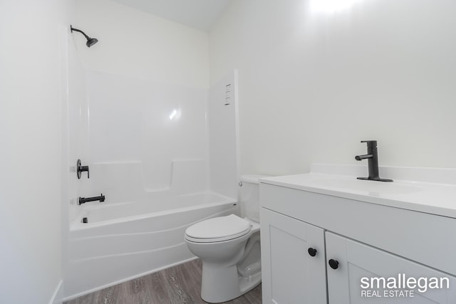 full bathroom with vanity, wood-type flooring,  shower combination, and toilet