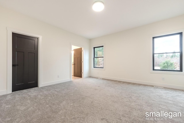 unfurnished bedroom featuring light colored carpet