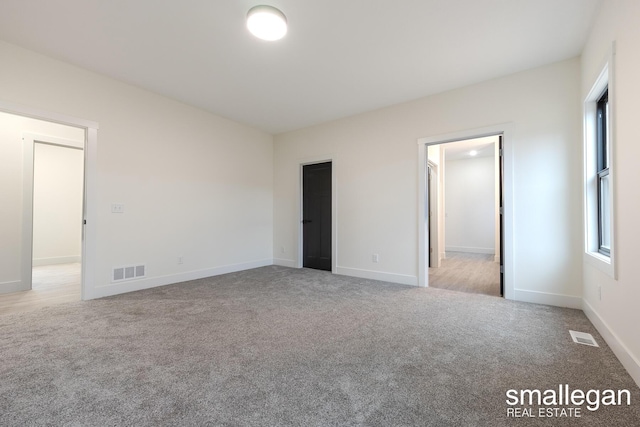 unfurnished bedroom with light carpet