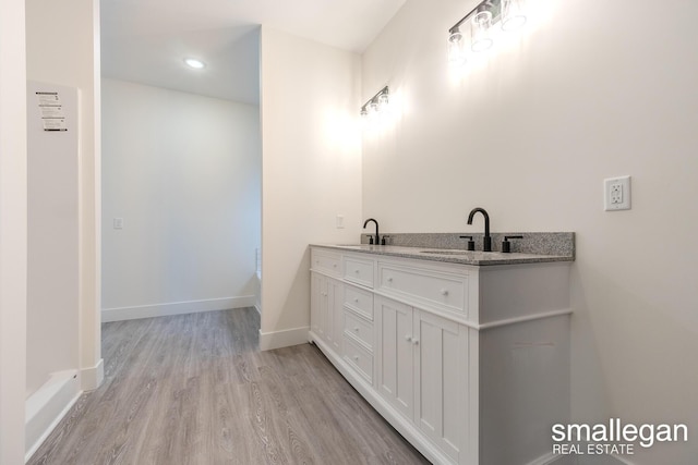 bathroom with vanity and wood-type flooring