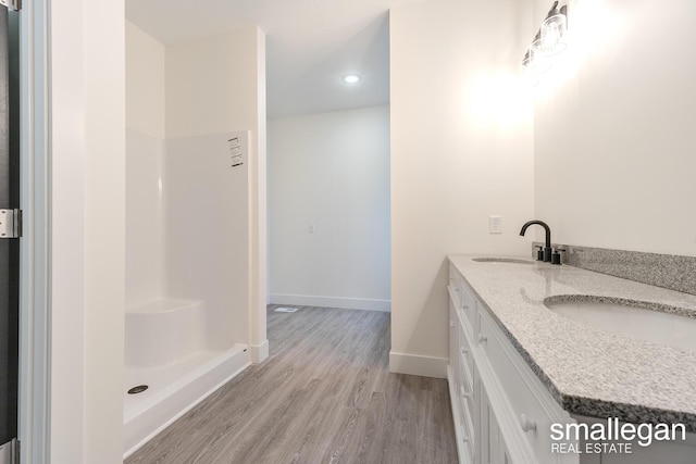 bathroom with hardwood / wood-style floors and vanity