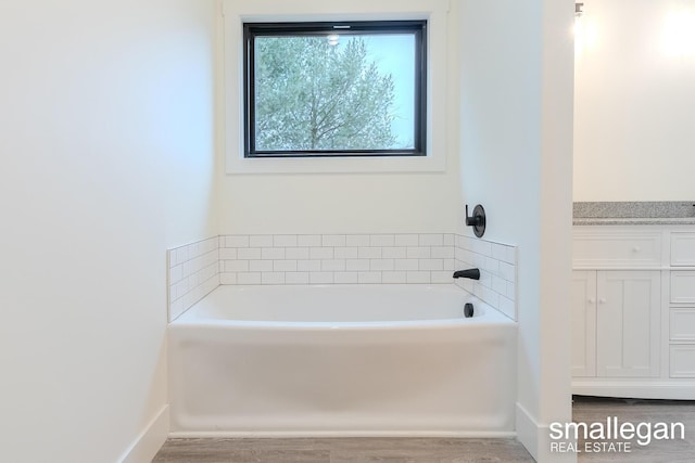 bathroom with a bathing tub and wood-type flooring