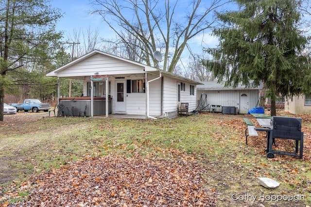 view of front facade with covered porch and a jacuzzi