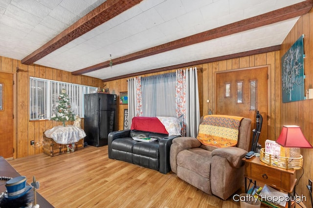 living room with beamed ceiling, wooden walls, and hardwood / wood-style flooring